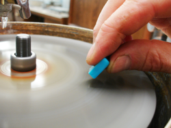 A photo which shows me hand-cutting the Turquoise on my machine.