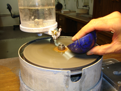 Photo shows me with a vary large Lapis cabochon cutting it on my lapping machine.