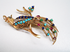 A bird pin with tiny cabochons of Lapis and Turquoise