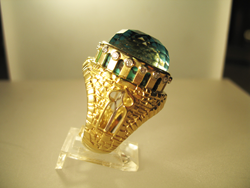 A side view of the finished ring where you can see the spiderweb Turquoise through openings on the side of the ring.