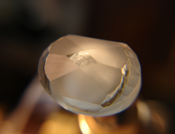 Photo showing the first steps of faceting the Aquamarine into a faceted cabochon