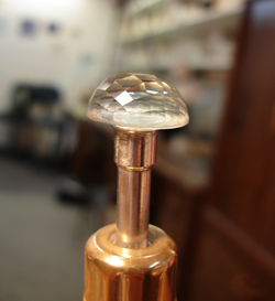 Photo showing the finished faceted cabochon still on the machine.