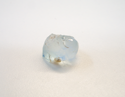 Shows a rounded light blue Topaz crystal from Colorado