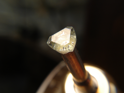 Shows me faceting the triangular Topaz into a trillion cut.