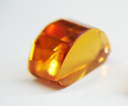 Photo of a yellow-orange Madiera Citrine with an arch shape.