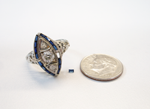 An antique diamond ring with tiny blue Sapphires.