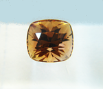 Photo of a brownish oval Tourmaline stone.