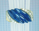 Ring inlaid with lapis that has 3 ribs carved into it.