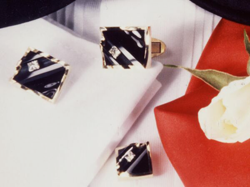 Photo of cufflinks and tux studs which have black Jade inlays and princess cut diamonds which slide in channels.