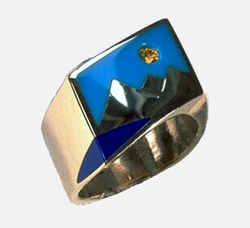 Inlay ring with a lake area which is inlaid with blue Lapis, a sky area made of Turquoise and a yellow Sapphire for a sun.