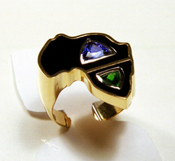 Ring shaped like Africa inlaid with Black Jade also containing a blue Tanzanit and a green Tsavorite.
