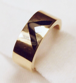 A men's band inlaid with a V shape of Black Jade and a small silvery square of Silicon.