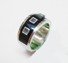 Picture of a ring inlaid which has holes in it.