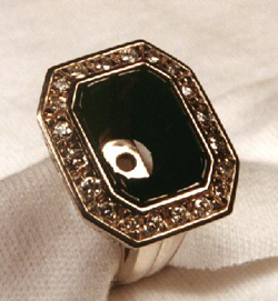 The carved black jade is set into the ring but the diamond is not yet in the center.