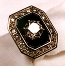 Small photo of a ring with Black Jade around a center diamond.