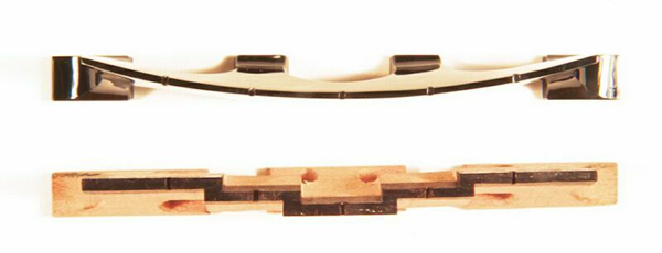 A wooden banjo bridge and one made from black jade from different angle.