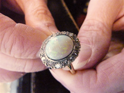 Shows the jeweler holding the finished ring.