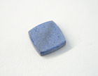 Photo of a cabochon which had the surface etched white by pickling solution and needed to be re-polished.