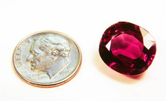 Photo of a cushion Rhodolite gemstone after it has been re-polished.