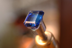 The emerald cut Tanzanite mounted in my faceting machine.