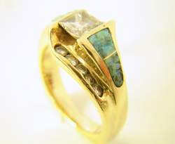 A ring with 4 Opal inlays in which the Opal is crushed and needs to be replaced.