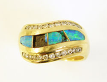 A ring inalid with Opal inlays which are broken.