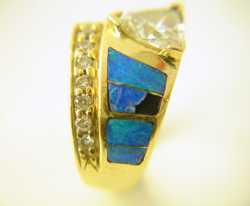 Opal inlay ring with a Trillion diamond with a broken inlay.
