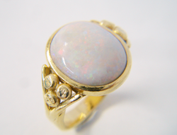 A ring with an Opal cab which is very scratched and dull.