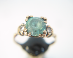 Photo of a ring with a Zircon which has a table and star facets which are very scratched and worn and need to be re-polished.