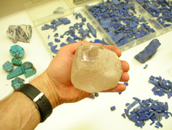 I am holding a piece of Quartz rough which is the size of a grapefruit.