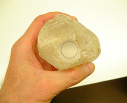 Shows a flat spot the size of a nickle I have ground onto the Quartz and a circle I have drawn on the flat spot with a pencil.
