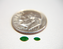 Photo of 2 tiny Jadeite cabochons which are marquise shaped.
