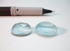 An Aquamarine faceted cabochon.