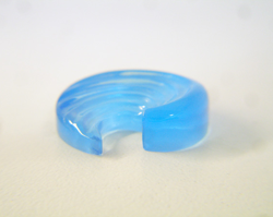 A side view of the finished blue topaz carving.