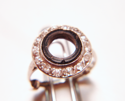Photo of an antique Diamond ring with a round black Onyx which is broken.