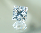 A square princess cut white synthetic sapphire.