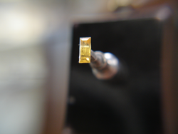 Shows a rectangular yellow sapphire during polishing