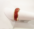 An 18 karat gold band inlaid 360 degrees around with petrified Dinosaur bone.