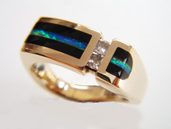 A ring inlaid with black Onyx and a long thin stripe of Opal.