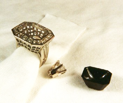 Ring with the finished black jade carving sitting next to it and also the diamond which will be mounted into it.