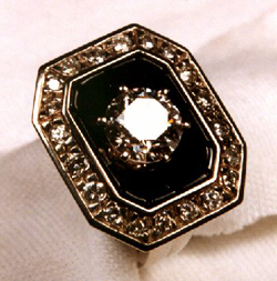 The carved black jade is set into the ring. The diamond is now set in the center.