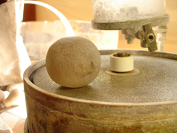 Shows a ball shape of Rutillated Quartz sitting on my grinding lap.