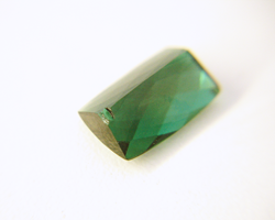 Photo of the same green Tourmaline with a chip in the pavilion.