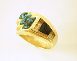 Picture of a ring with Turquoise on top and a broken Black Jade inlay on the side of the ring.