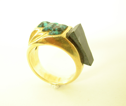 Picture showing a piece of Black Jade which has been inlaid into the ring and glued in place.