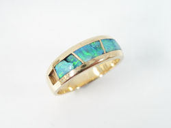Show a ring with 4 Opal inlays which are all either missing or broken or cracked.