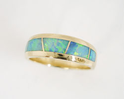 Shows the finished ring which has been inlaid with 4 new Opal inlays.