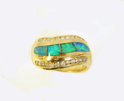 Shows the finishe ring with 2 new Opal inlays in the center which match the other inlays.