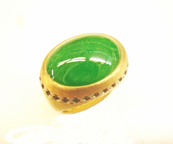 A ring with an intensely green Impaerial Jadeite cabochon which has been re-polished.