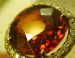 Another close up photo showing scratches on the table of the orange Spessartite.